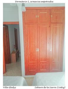 a bedroom with wooden cabinets in a room at CASA GLADYS in Zahara de la Sierra