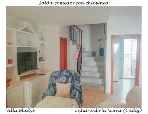 a living room with a chair and a staircase at CASA GLADYS in Zahara de la Sierra