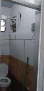 a small bathroom with a toilet and a window at Quitinete Expominas Suite Ar in Belo Horizonte +17 photos