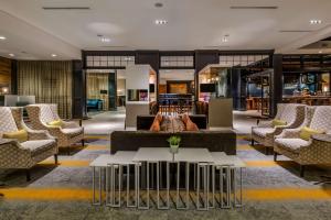 a lobby with couches and tables in a building at Sonesta Charlotte Lower South End in Charlotte