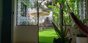 a door leading to a yard with a green lawn at Green life in San Salvador