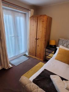 a bedroom with a bed and a large window at Mel's Springfield Home in Manchester