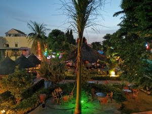 an outdoor restaurant with tables and chairs at night at Le Baobab in Bamako