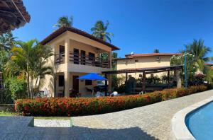 ein Resort mit einem Pool und einem Gebäude in der Unterkunft Casa em Antunes Maragogi Condomínio Beira Mar in Maragogi