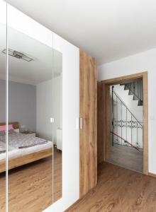 a bedroom with a bed and a sliding glass door at Ferienwohnung Yilmaz in Bruck an der Großglocknerstraße