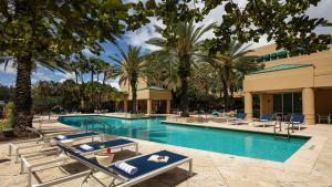 a swimming pool with a pool table and chairs at InterContinental at Doral Miami, an IHG Hotel in Miami