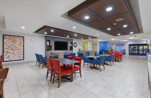 a waiting room with tables and chairs in a hospital at Holiday Inn Express Hotel & Suites Mount Juliet - Nashville Area by IHG in Mount Juliet