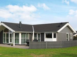 een huis met een hek ervoor bij 7 person holiday home in Hadsund in Hadsund