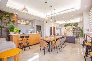 a restaurant with a table and chairs and a couch at Wild Tour in Jinning