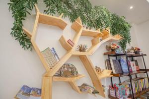 a wooden book shelf on a wall with books at Wild Tour in Jinning