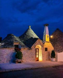 a stone building with a light on top of it at Trulli Resort Dimore Storiche in Alberobello