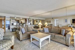 a living room with two couches and a table at Rainbow Condos II in Ocean City