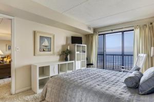 a bedroom with a bed and a large window at Rainbow Condos II in Ocean City