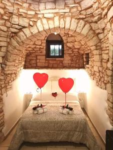Postel nebo postele na pokoji v ubytování Trulli Resort Dimore Storiche