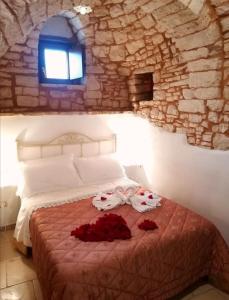Postel nebo postele na pokoji v ubytování Trulli Resort Dimore Storiche