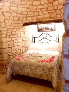 Postel nebo postele na pokoji v ubytování Trulli Resort Dimore Storiche