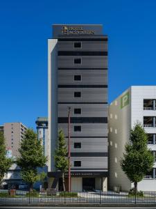 a building with a sign on the top of it at Hotel Act Garden HAMAMATSU in Hamamatsu