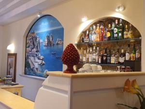 a bar with a bunch of bottles of alcohol at Hotel Cala Marina in Castellammare del Golfo