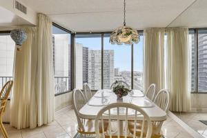 a dining room with a table and chairs and a large window at Capri II in Ocean City