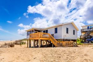 a house on a wooden deck on the beach at The Sea Salt Cottage at Geri's Place 304 in Nags Head