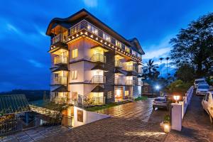 a tall building with balconies on the side of it at Ramee Wolkenburg Resort & Spa, Munnar in Munnar