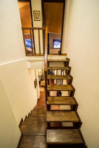 a staircase in a house with wooden floors at Holiday In Homestay in Shimla