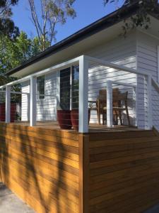 a screened in porch on a wooden deck at STUDIO ECHUNGA Adelaide Hills in Echunga