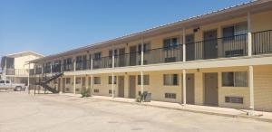 an apartment building with a staircase on the side of it at Gold Key Inn in Brady