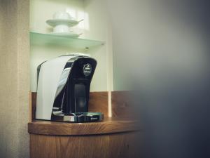 a coffee maker sitting on a wooden shelf at Schlichte Hof GmbH in Bielefeld