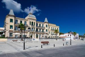 a large building with a flag on top of it at Argonaftis Spetses in Spetses