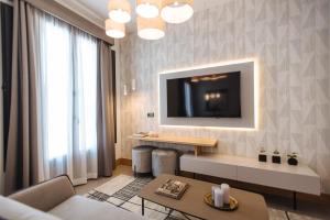 a living room with a television on a wall at Guadalupe 15 by Magno Apartments in Seville +159 photos