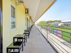 a row of benches on a building with a balcony at SUPER OYO 90622 Hotel Galaksi in Ponorogo