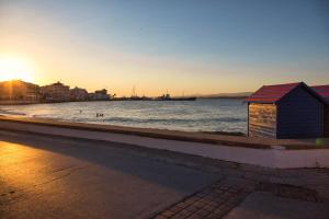 a small building sitting on the side of a beach at Aria Apartments in Spetses