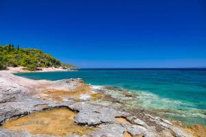 a view of the ocean from a rocky beach at Aria Apartments in Spetses