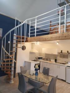 a kitchen and dining room with a table and a staircase at Grange cottages in Edenderry