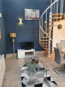 a living room with a staircase and a glass table at Grange cottages in Edenderry