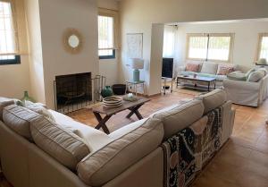 a living room with a couch and a table at Chalet con encanto cerca de Sevilla in Alcalá de Guadaira