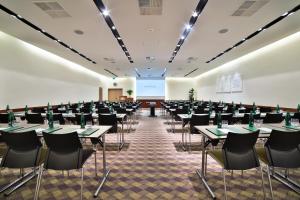 a room filled with tables and chairs in a room at Botanique Hotel Prague in Prague