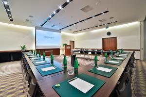 a conference room with a long table with green napkins at Botanique Hotel Prague in Prague