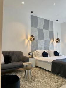 a living room with a bed and a couch at VenaRi apartments, Rijeka in Rijeka