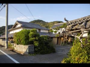 a house with a street and a building with at Cafe Restaurant Umi no Yado Awaji Island - Vacation STAY 61253v in Awaji