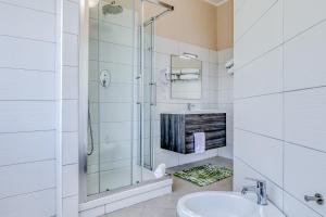 a white bathroom with a shower and a sink at Asso Residence Centro in Terni +11 photos