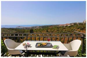 a plate of food on a table on a balcony at Apartment STAR Blažev in Primošten