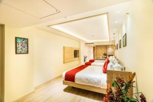 a hotel room with a bed and a skylight at Hotel Jagadish International-Sankey Road in Bengaluru +53 photos