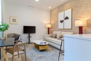 a living room with a couch and a table at Genteel Home Feria in Seville