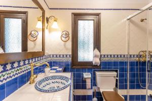 a blue tiled bathroom with a toilet and a sink at Villa Paraíso Azul in Salobreña +31 photos