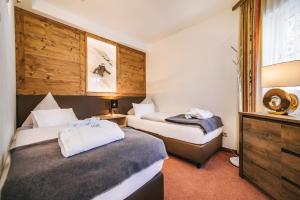 Łóżko lub łóżka w pokoju w obiekcie Arlen Lodge Hotel inkl Premium Karte im Sommer