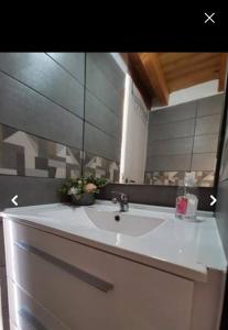 a bathroom sink with a mirror on top of it at Casinhas Proença - Family in Aljezur +12 photos