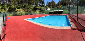 a swimming pool on a red carpet at Vistas al mar 2 Canabal in A Coruña
