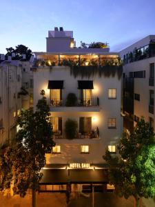 a building with a hotel sign on the side of it at Hotel Saul in Tel Aviv